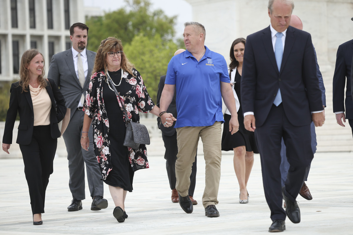 Joe Kennedy holds hands with wife, Denise, after his Supreme Court hearing